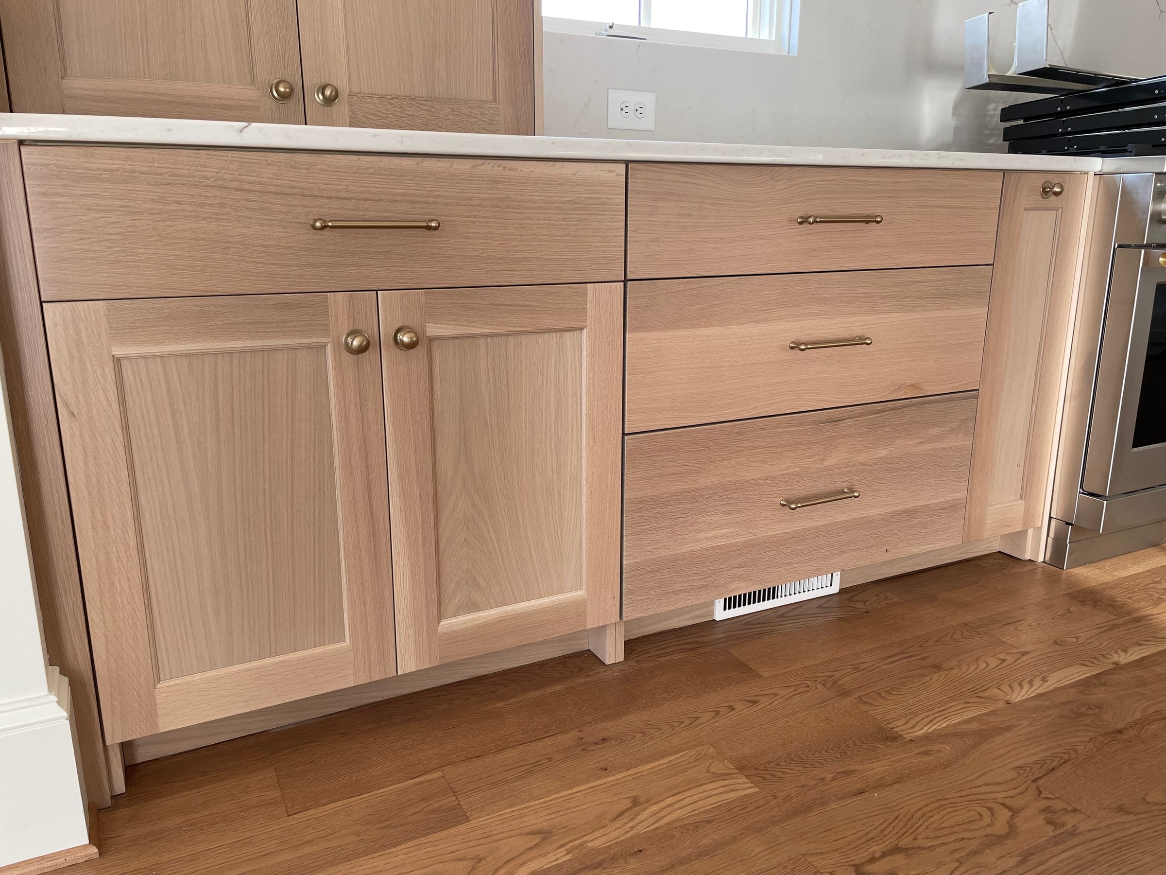 White oak drawer and door fronts with brass pulls